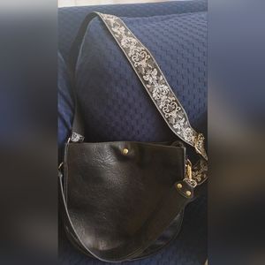 Crossbody black faux leather bag with guitar strap